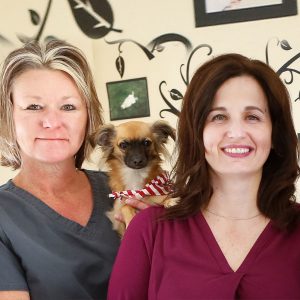 close up of two ladies with dog